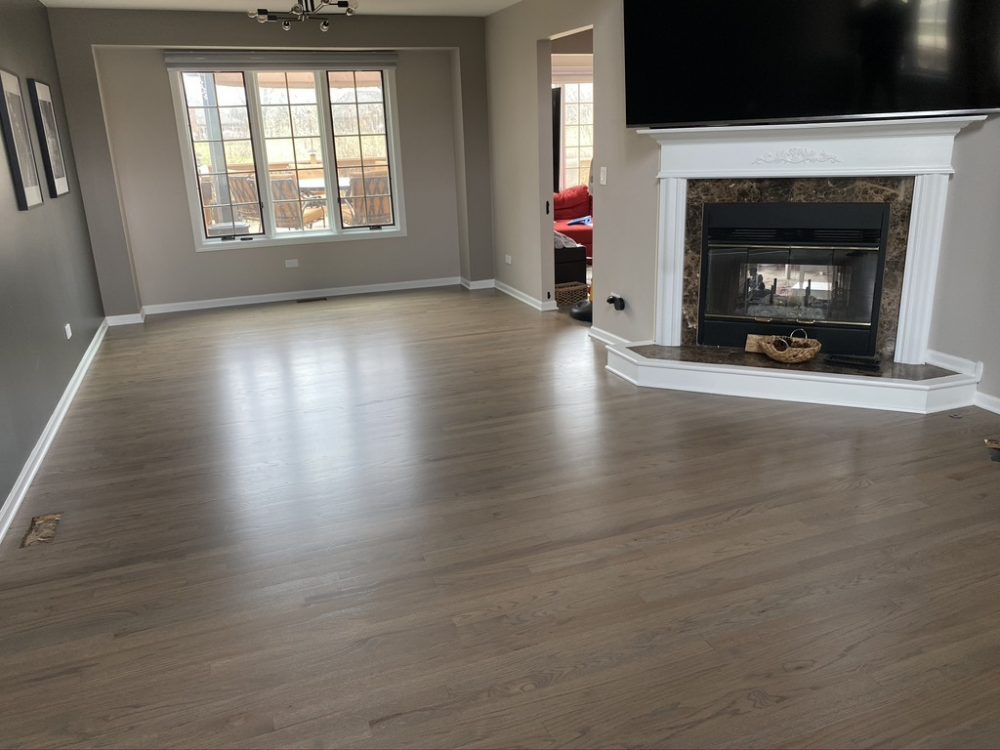 Living room with a fireplace and refinished hardwood floor