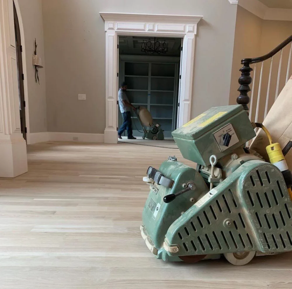 A professional drum hardwood sander in action