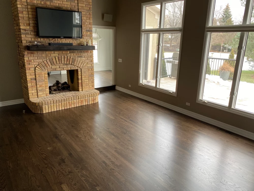 Refinished hardwood floors with a fireplace