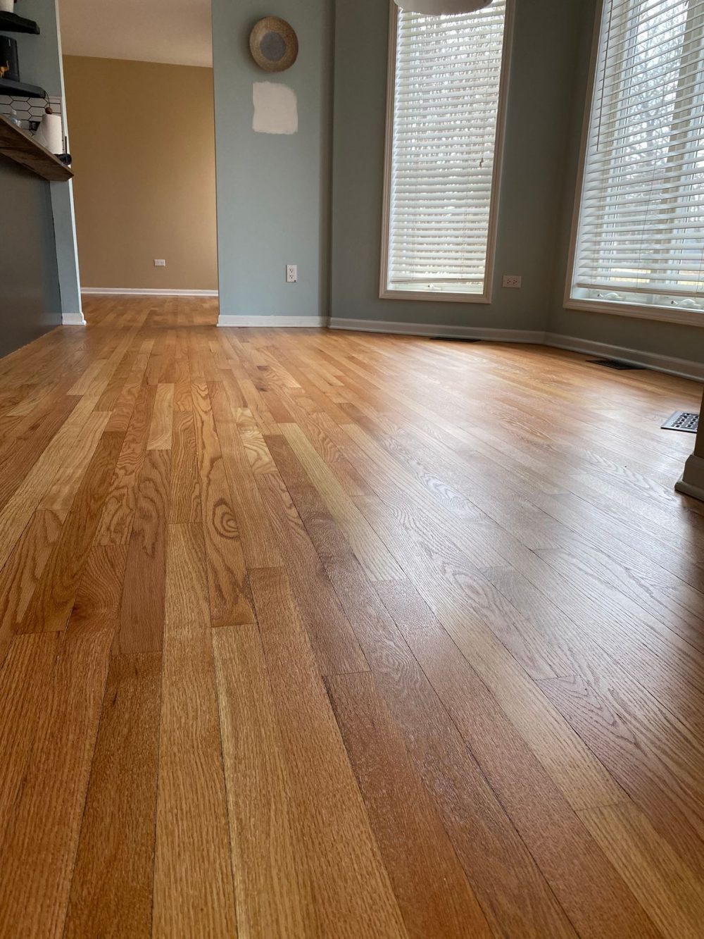 Close view of oak hardwood floors, satin wood floor finish by windows.