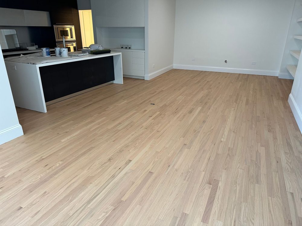 Finished red oak floors in open kitchen space with natural look
