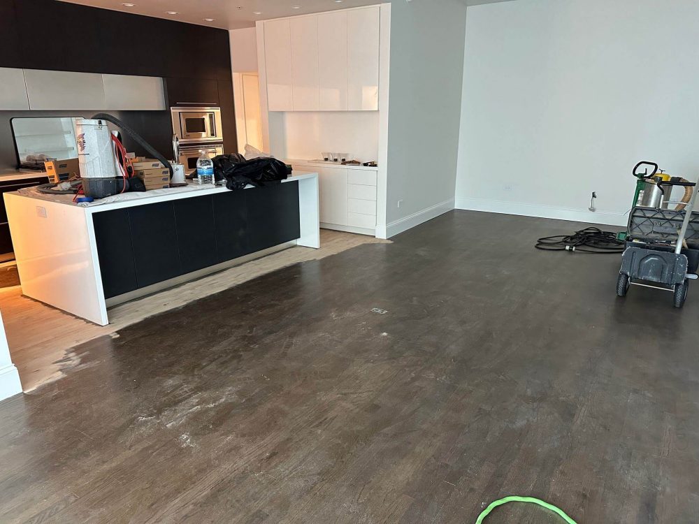 Stain removal work on red oak floors near kitchen and cabinets