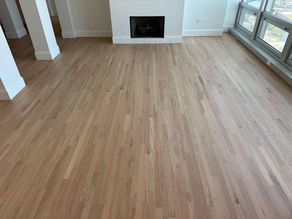 Refinished red oak floors in living room with consistent wood grain and light tone