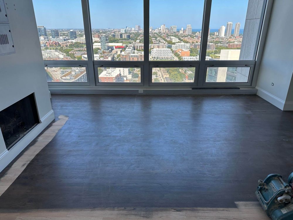 Sanding red oak floors in progress, surface prepped for stain and finish