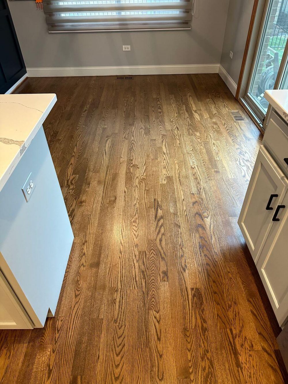 Restored oak kitchen walkway after floor refinishing and Provincial stain application