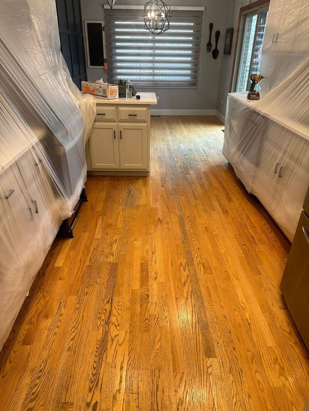 Close view of a worn oak floor before restoration showing discoloration and finish loss
