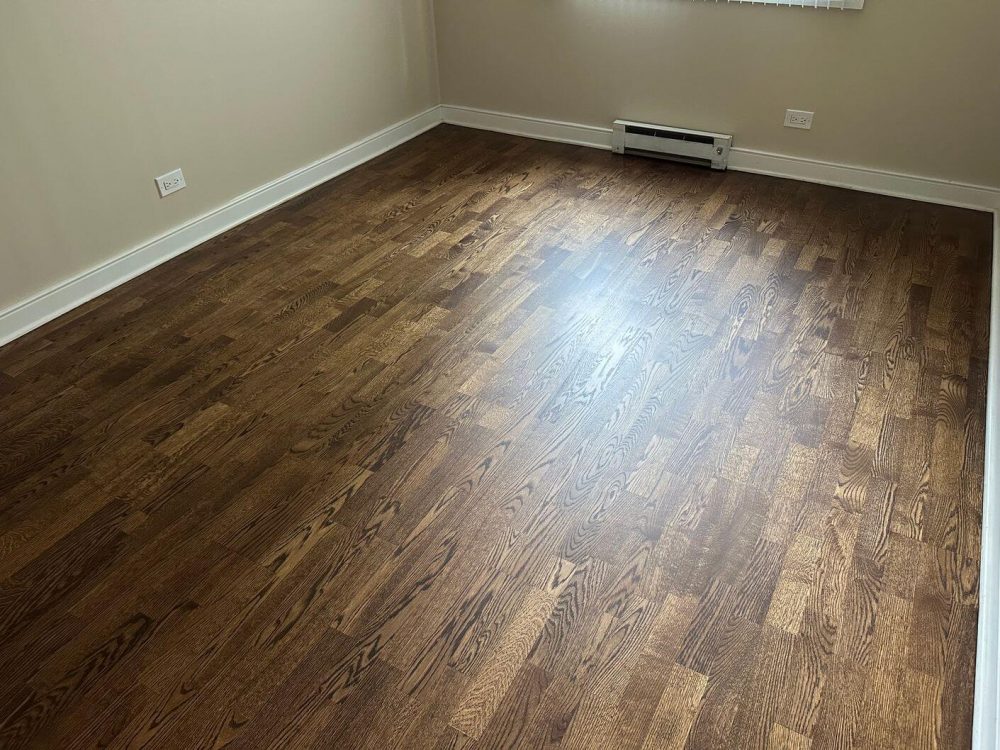 After we refinished and stained it, the bedroom floor had a darker, richer tone that gave the room a more updated feel.