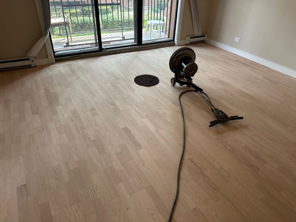 The engineered white oak floor after we sanded it down to a clean raw surface and removed the old finish.