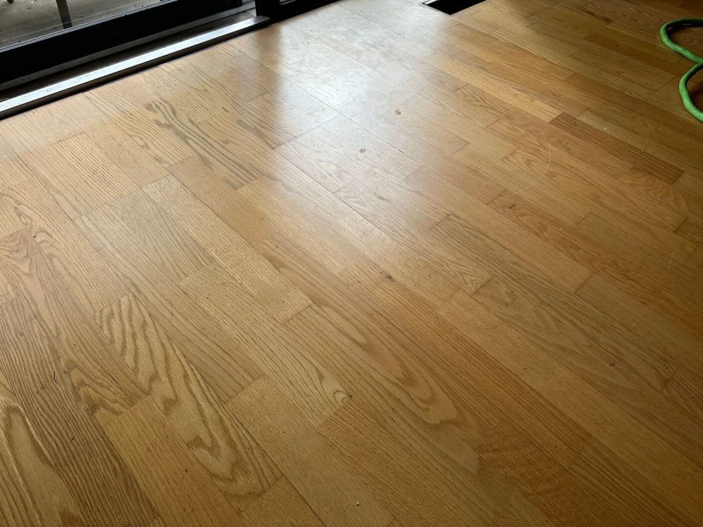 Before we refinished them, the engineered white oak floors in this Burr Ridge condo looked dull, worn, and dated.
