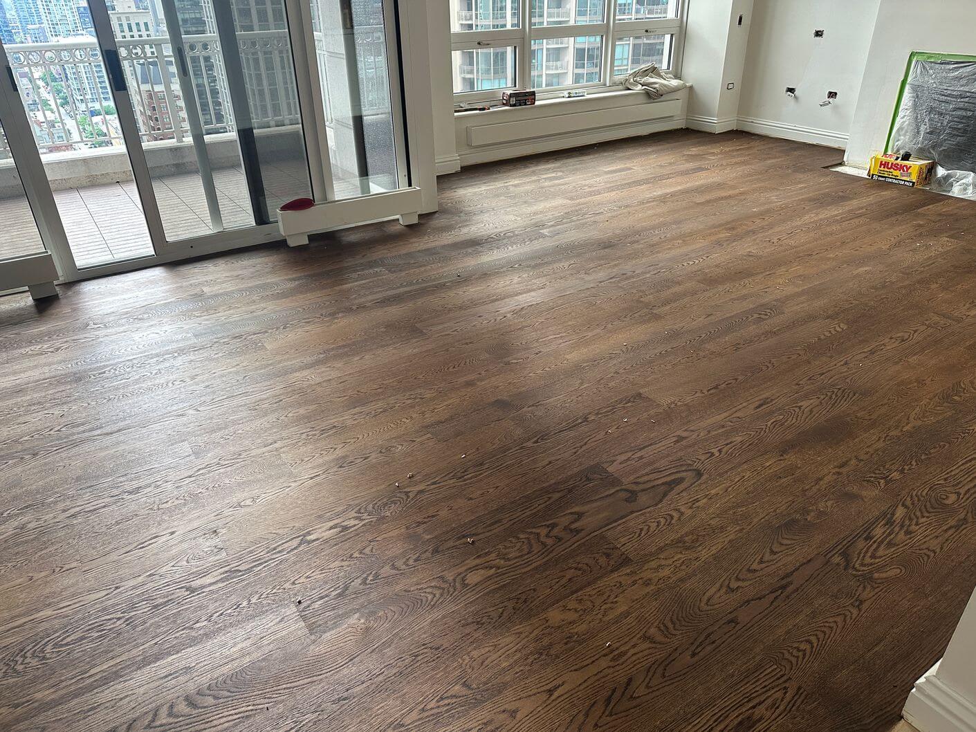 Engineered white oak floor after Antique Brown stain was applied, showing the darker color and visible wood grain.