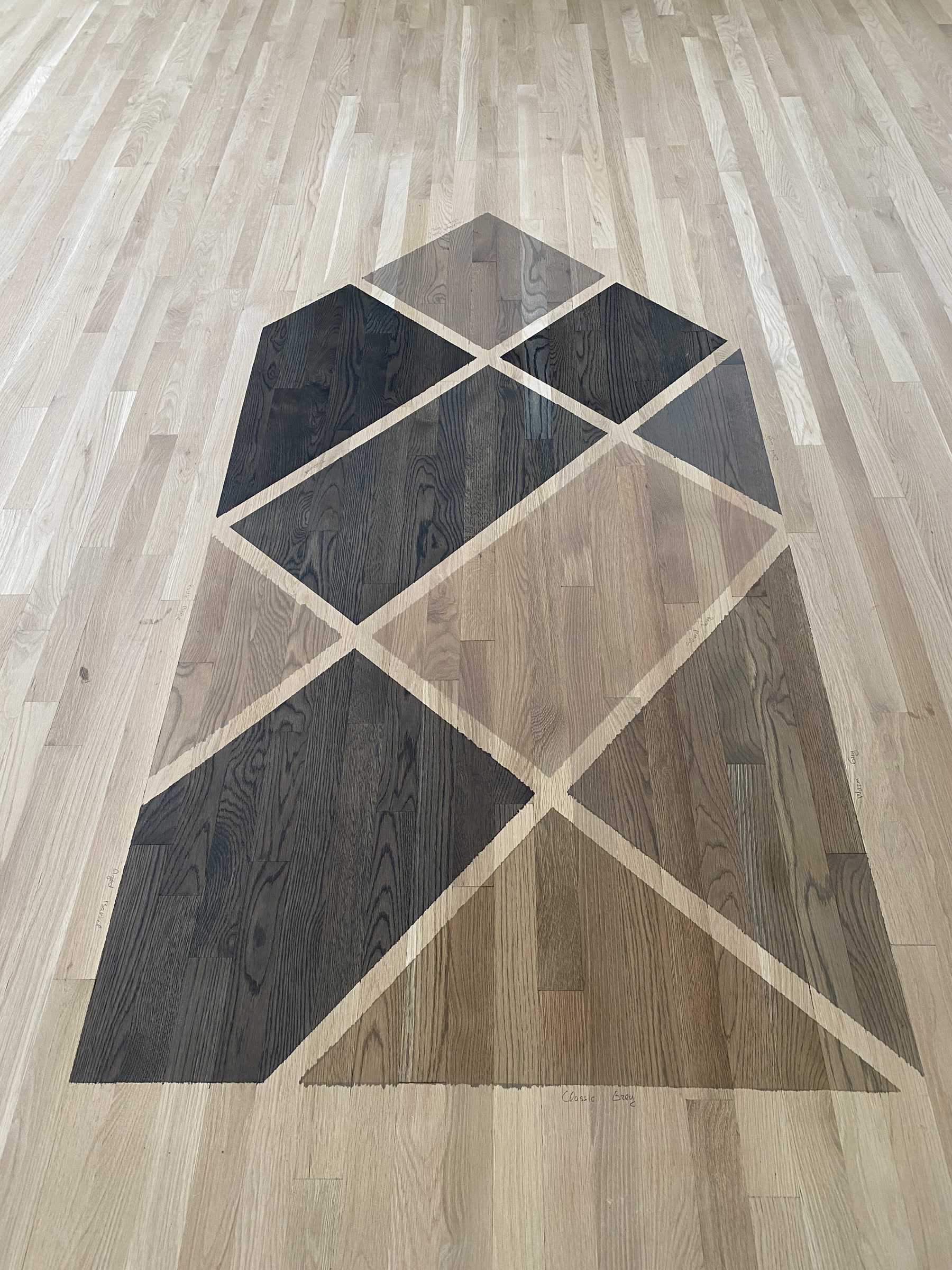 Silvered grey stain color samples laid out on the floor, Arlington Heights, IL