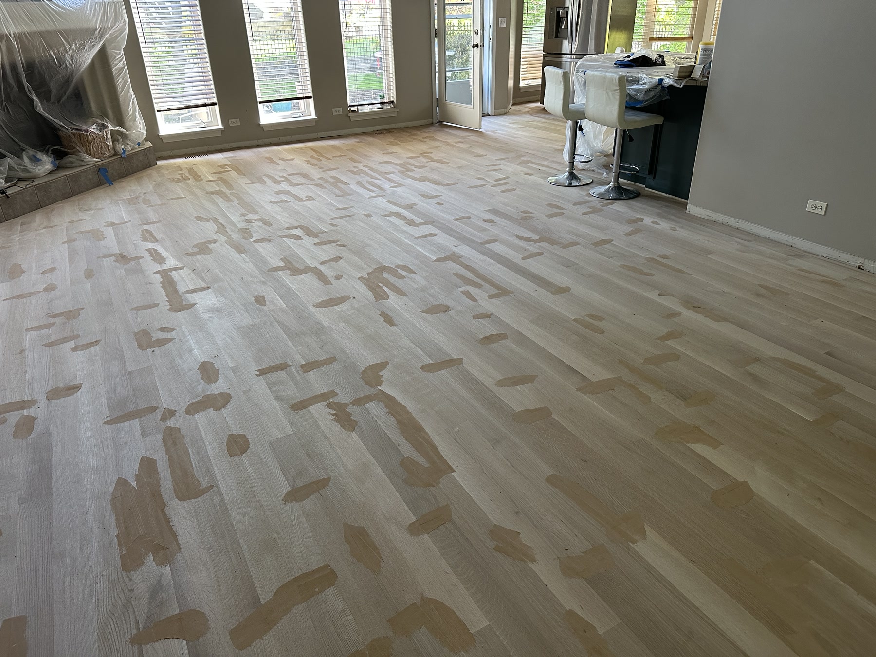 Great room floor sanded to bare wood in a patchwork before finishing, Aurora, IL (in-process)