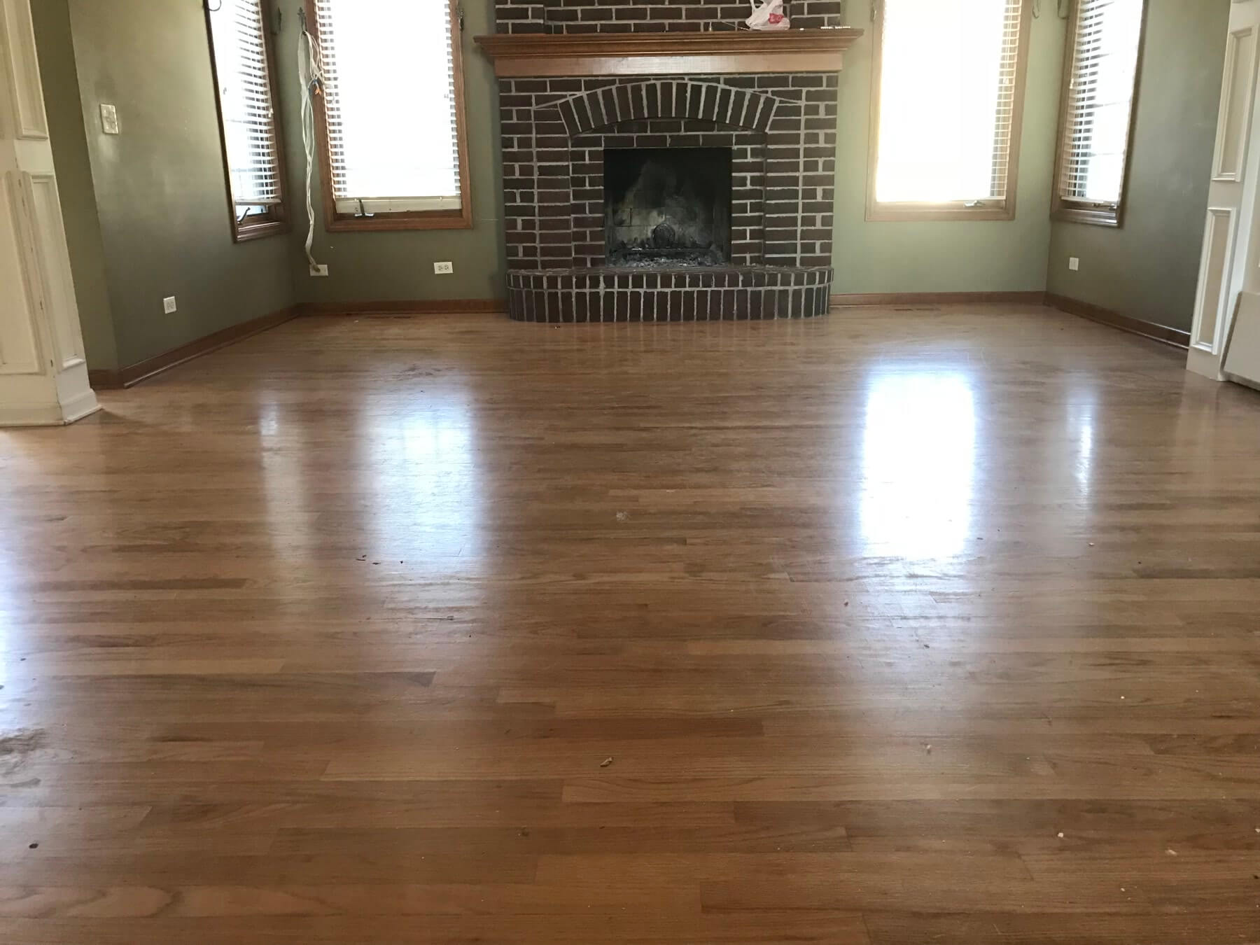 Great room with brick fireplace in Batavia, IL before espresso refinishing