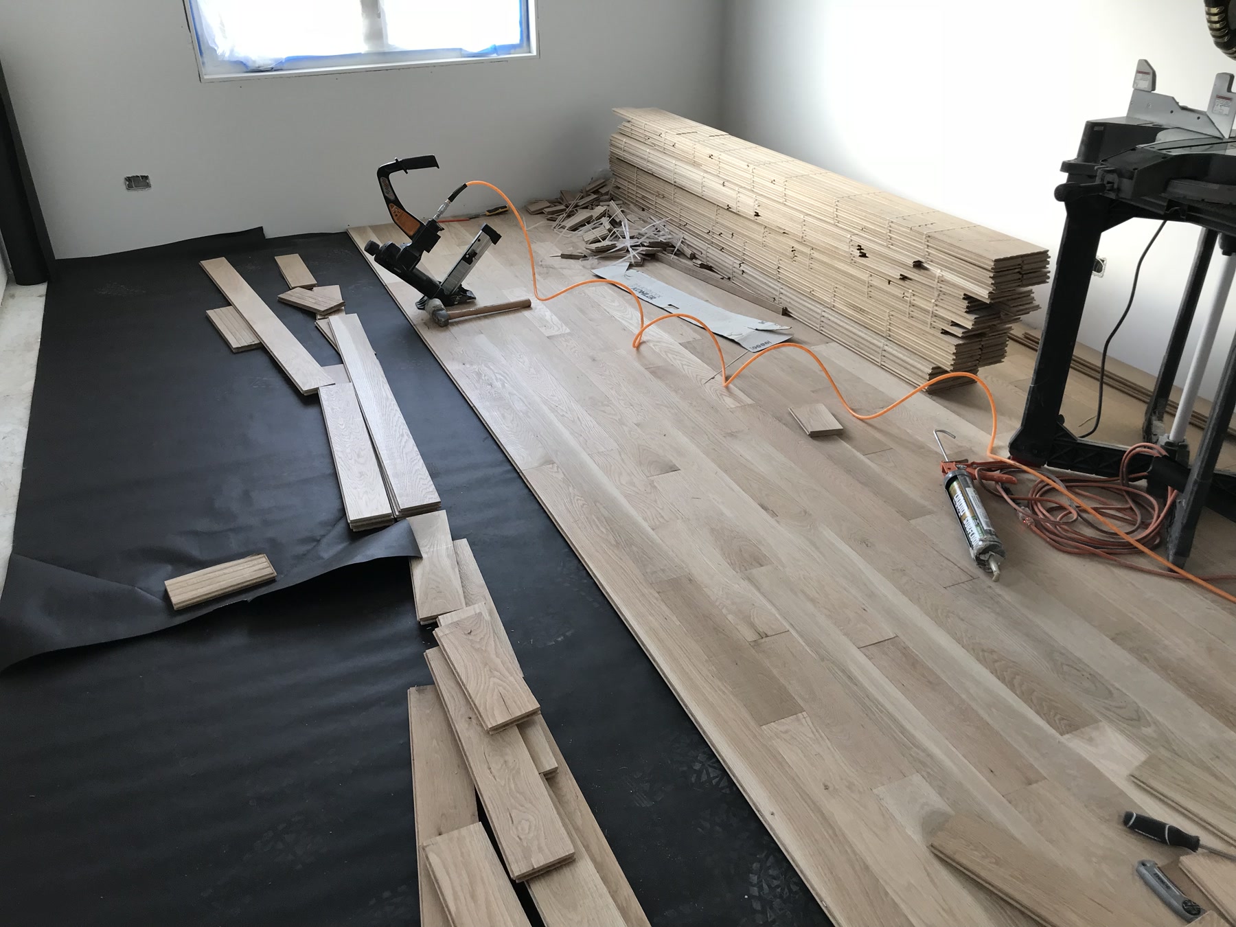 New 5-inch white oak boards being installed over the subfloor in Berwyn, IL