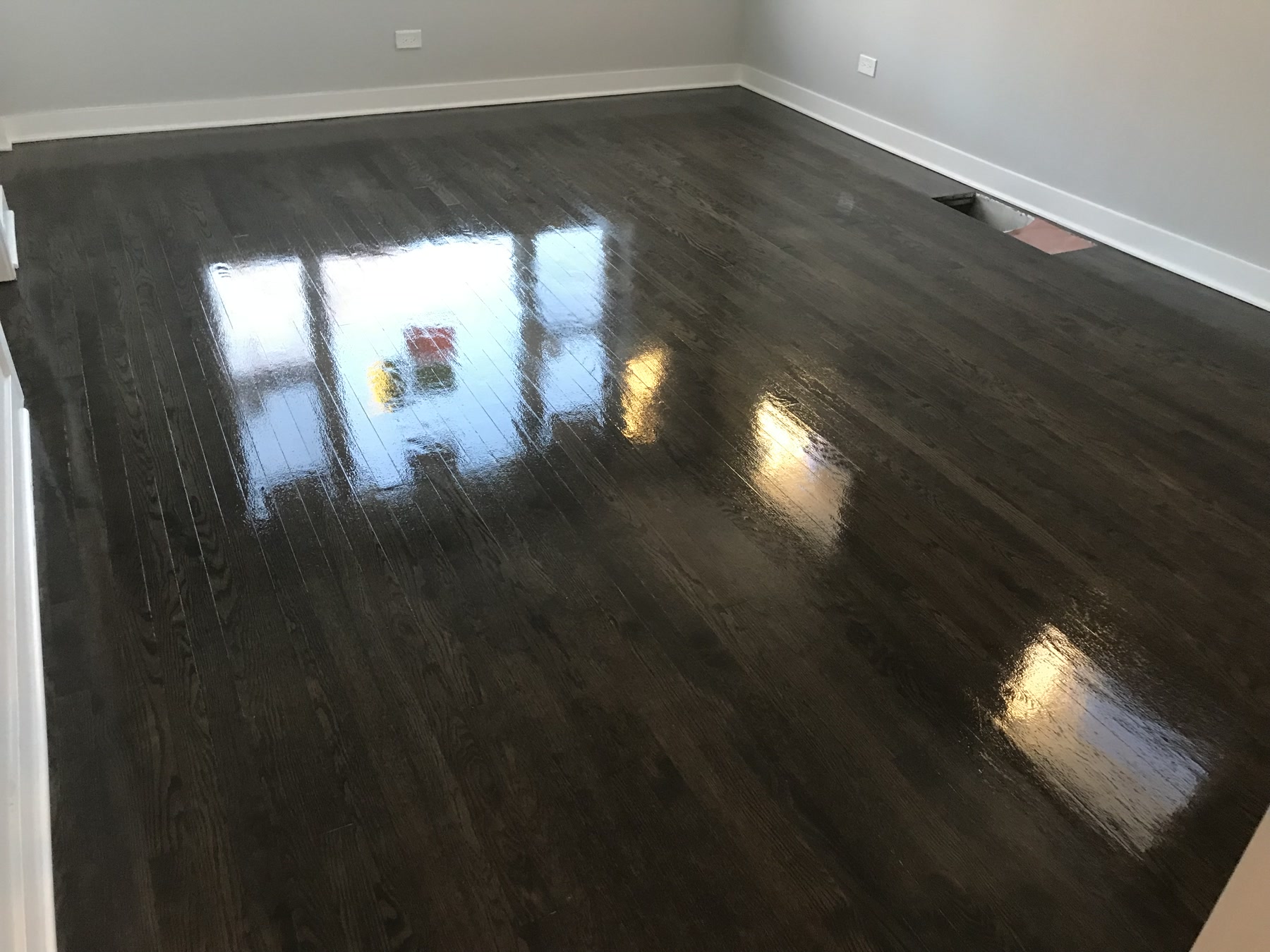 Hardwood floor refinished a deep ebony in the living room, Berwyn, IL