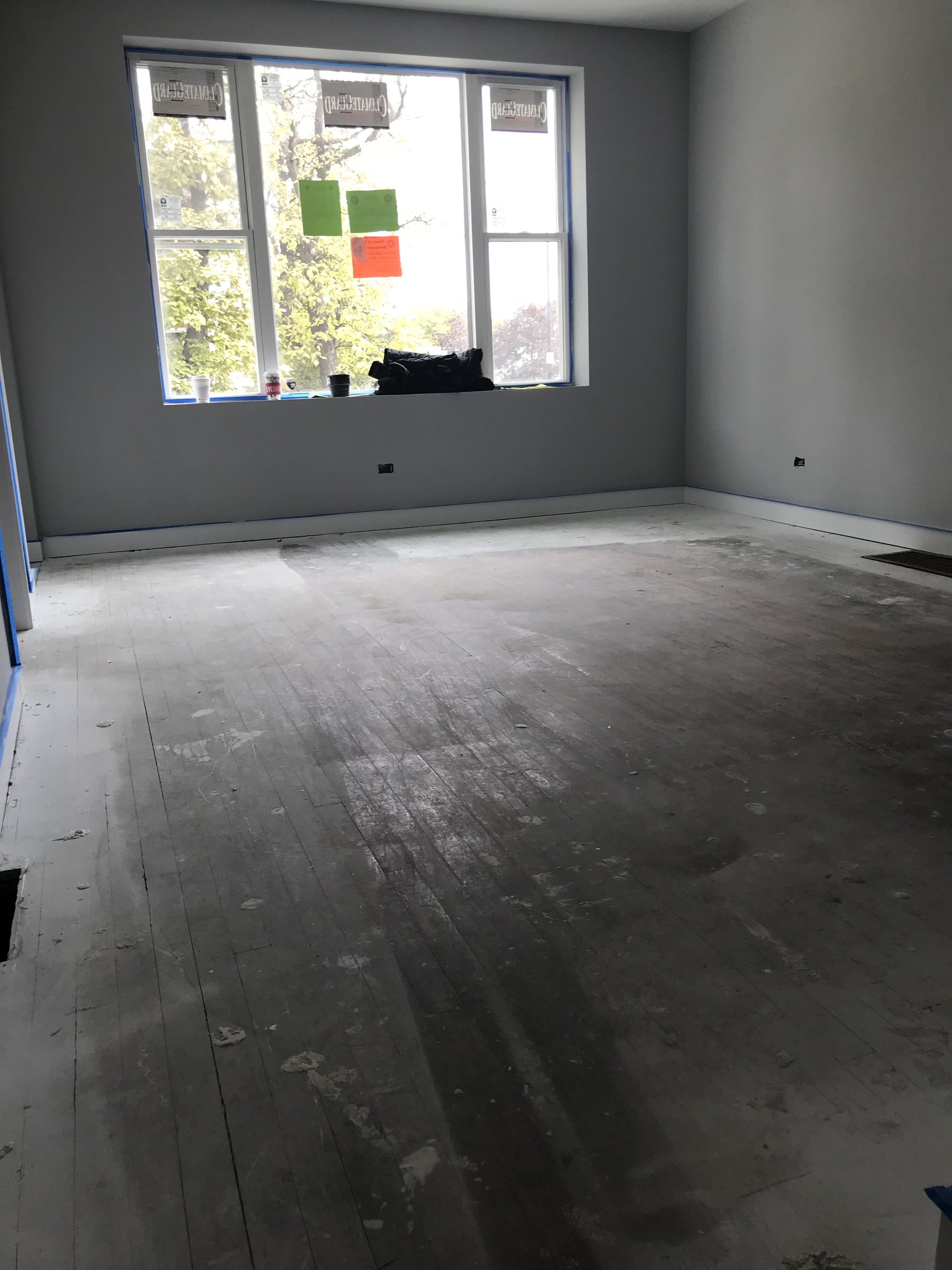 Worn, gapped hardwood floor before refinishing in Berwyn, IL