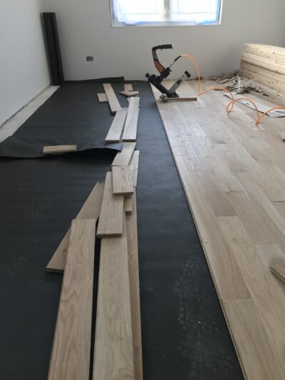 White oak plank installation in progress with a flooring nailer, Berwyn, IL