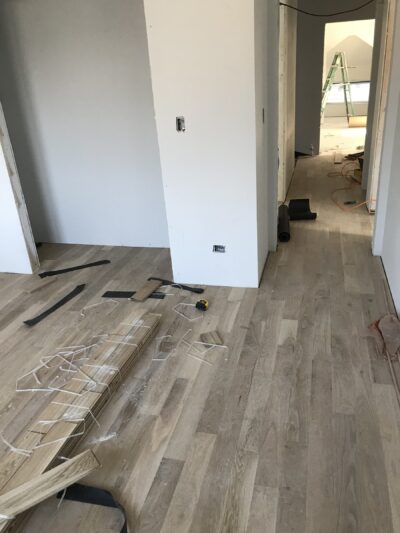 Laying new 5-inch white oak boards over the underlayment, Berwyn, IL (in-process)
