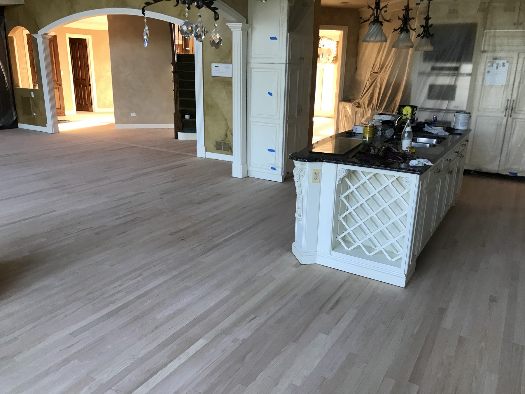 Raw, sanded hardwood floor in the kitchen before Medium Brown staining, Burr Ridge, IL (in-process)