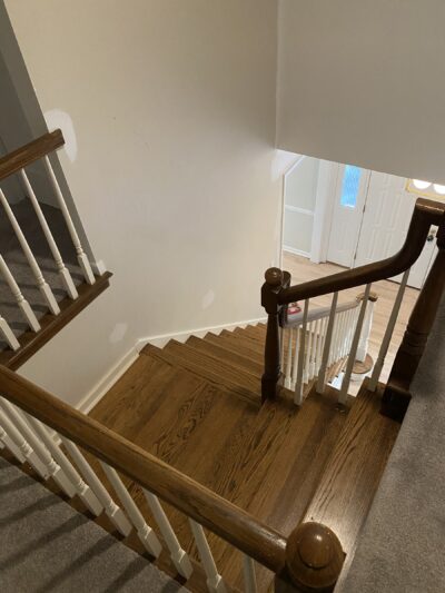White oak staircase seen from above with a wood handrail, Burr Ridge, IL