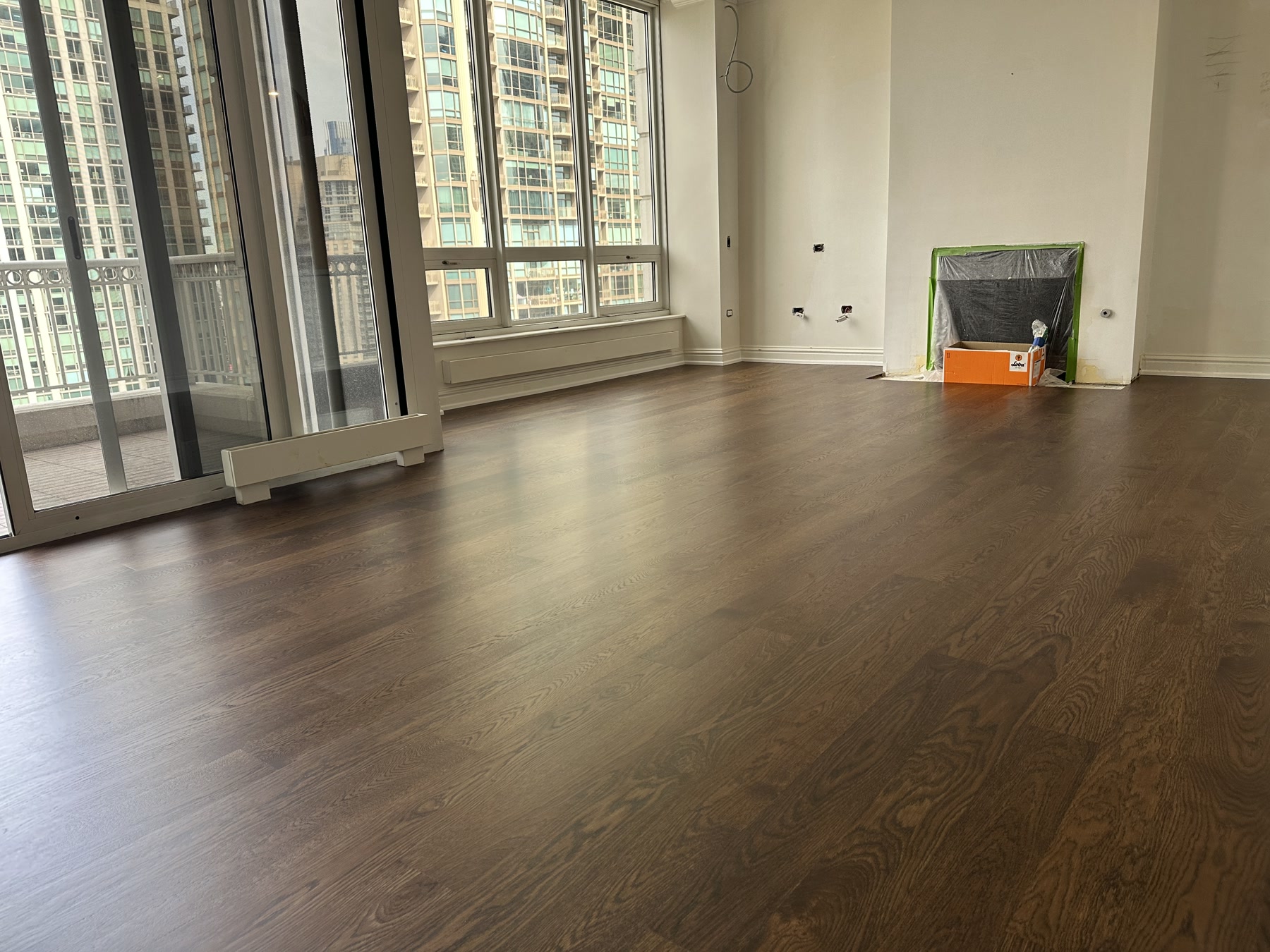 Finished medium brown engineered white oak floor with skyline windows, Chicago, IL