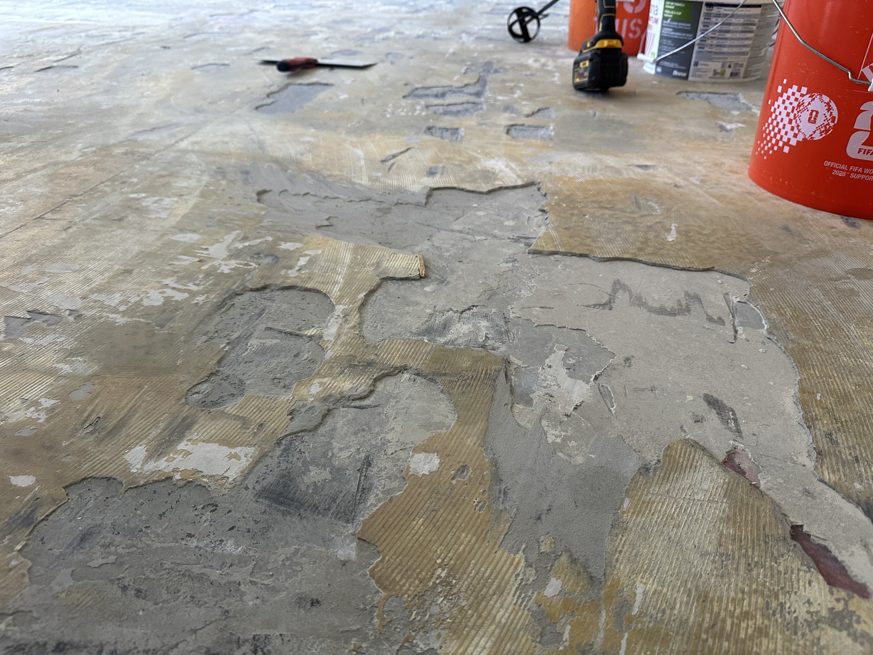 Old glued-down floor demoed to bare concrete in a downtown Chicago high-rise, IL