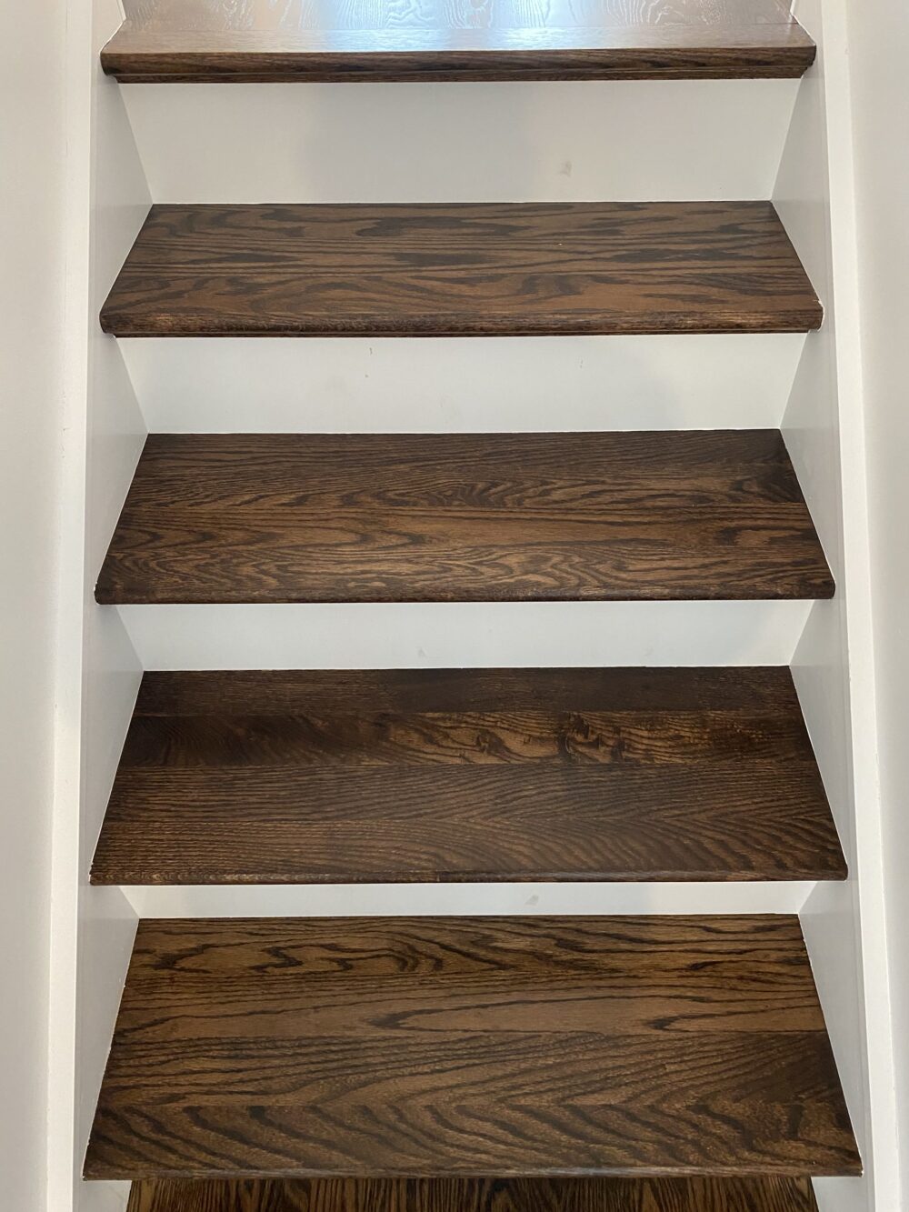 Close view of coffee brown open-riser stair treads, Chicago, IL
