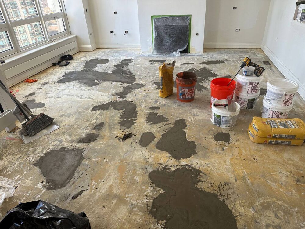 Damaged areas of the concrete subfloor patched and repaired before installing the new flooring system.