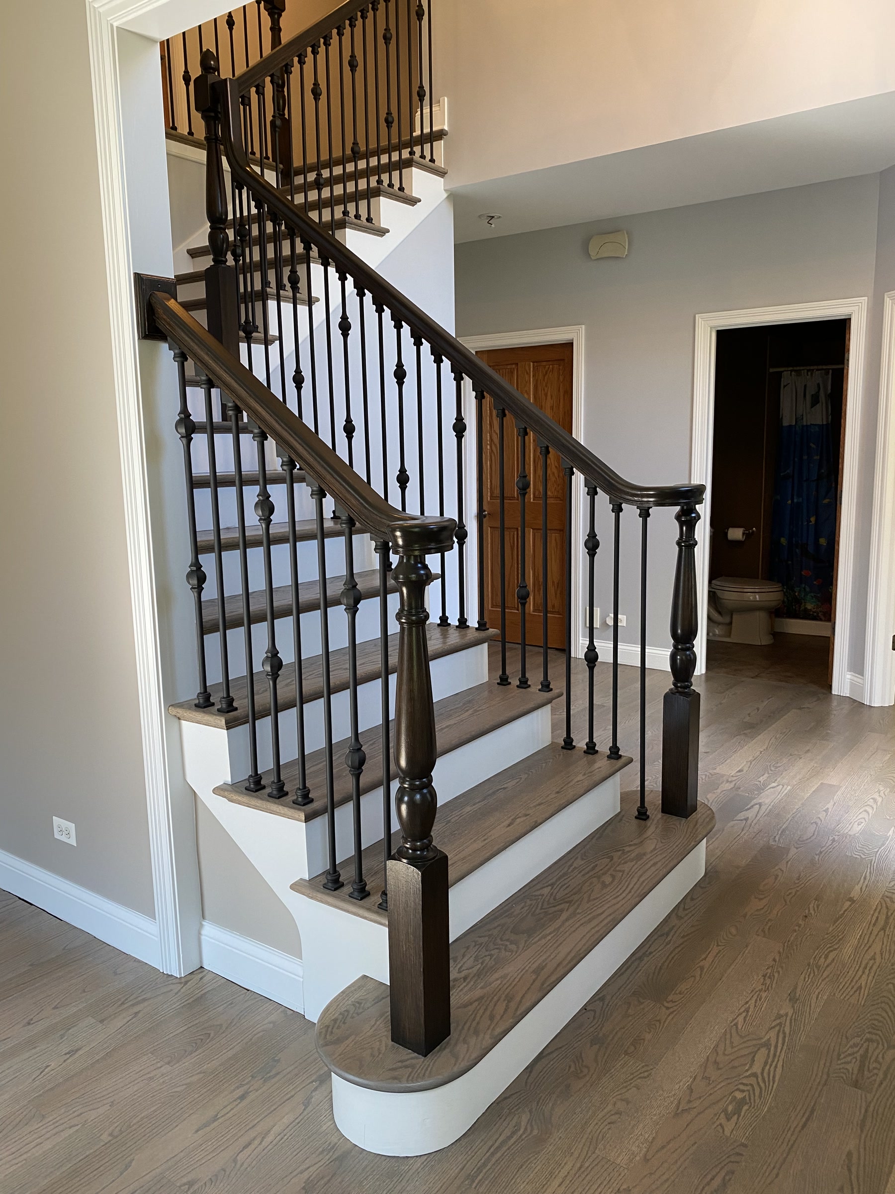 Staircase refinished with Classic Grey treads and black iron balusters, Darien, IL