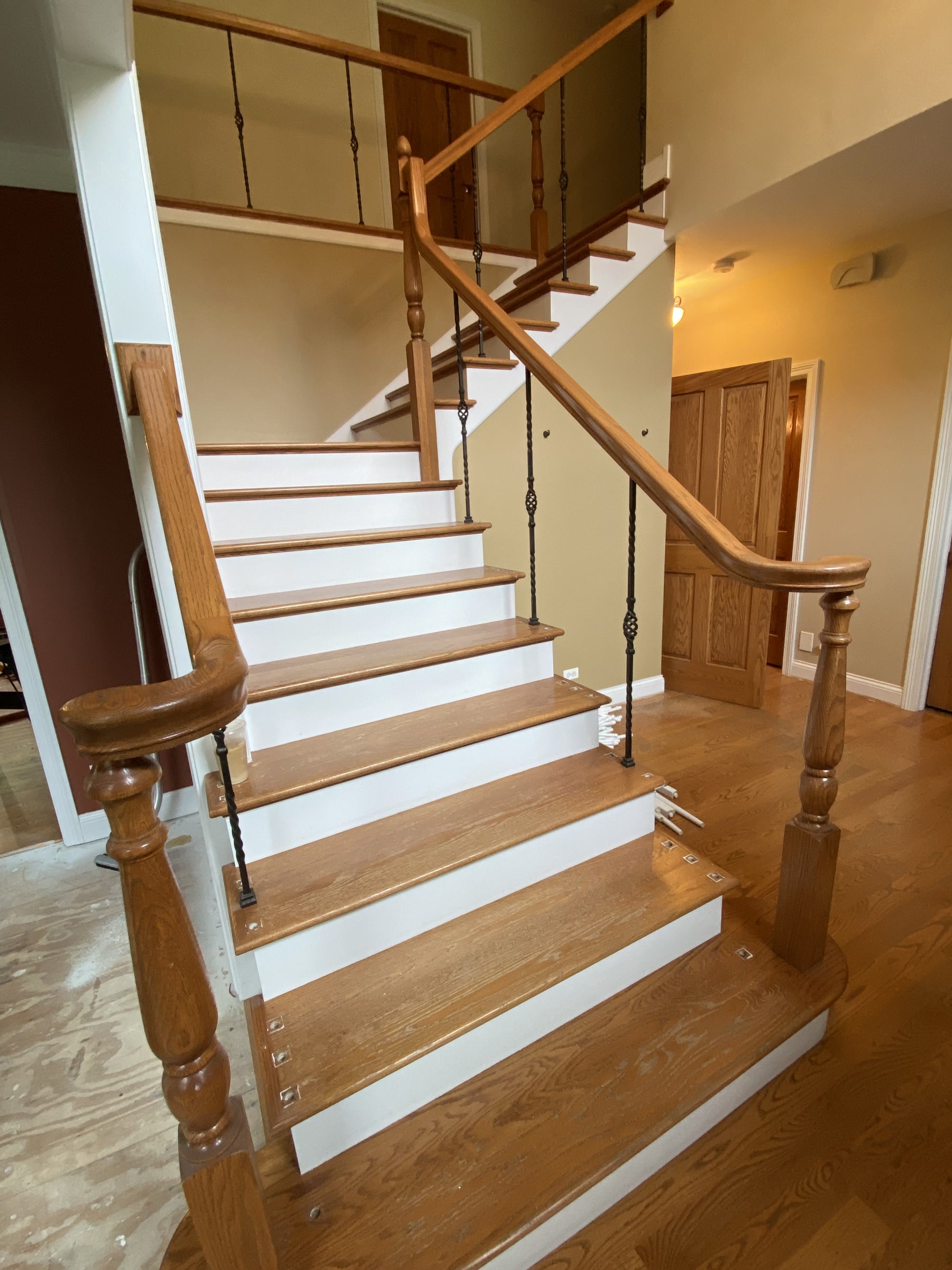 Staircase with wood balusters and natural treads before refinishing, Darien, IL