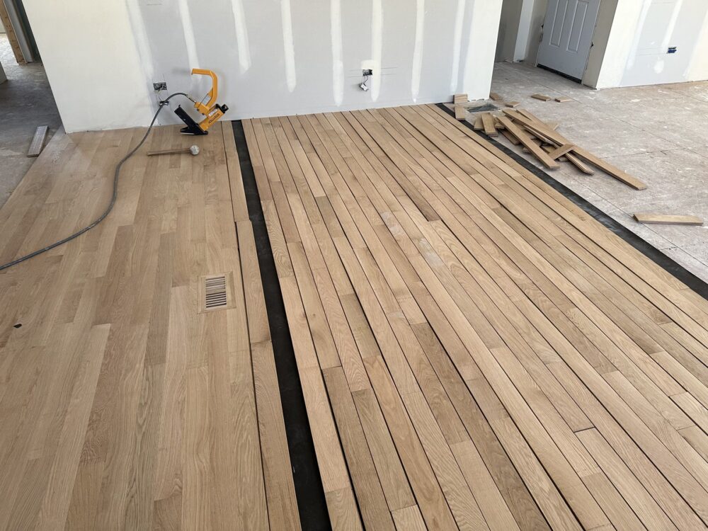 Laying new white oak boards over the underlayment, Darien, IL (in-process)