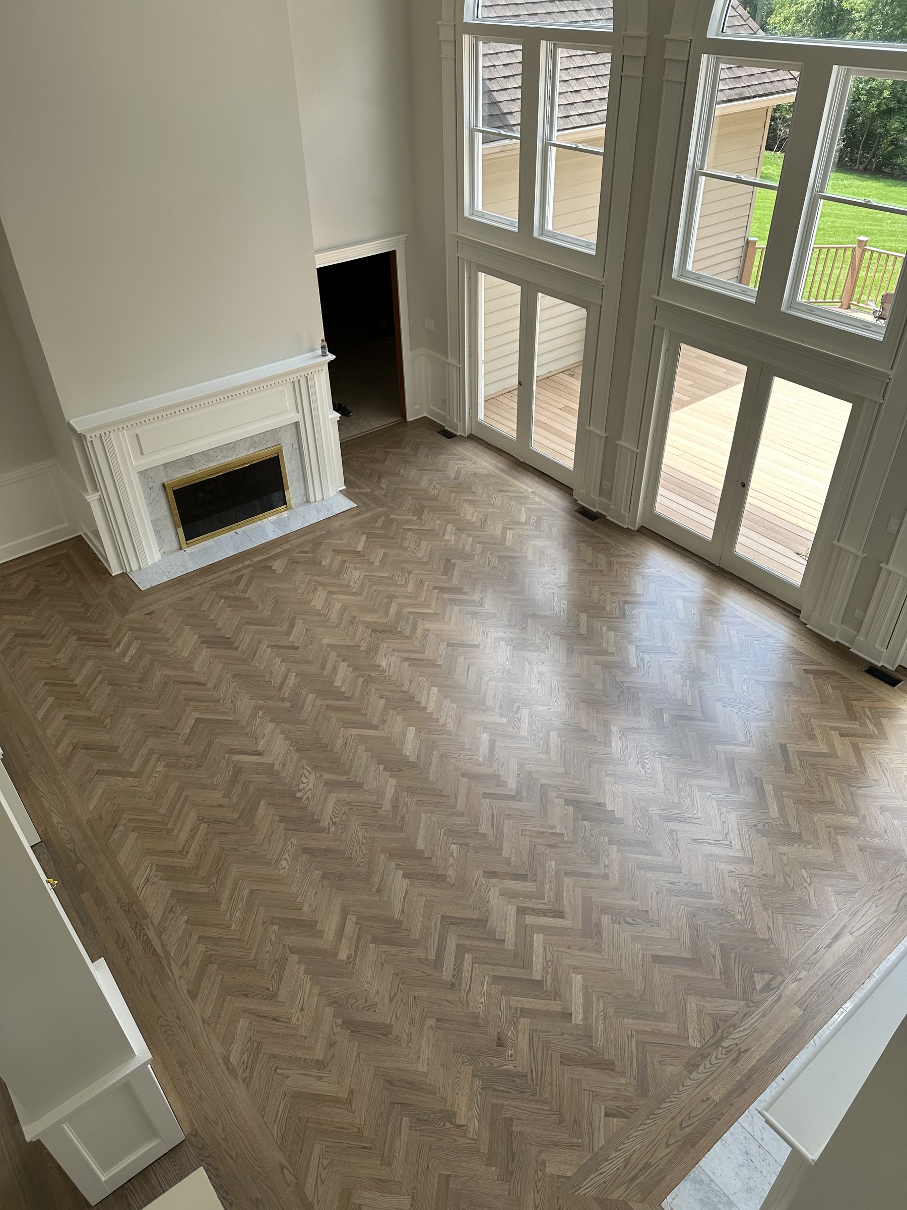 Herringbone white oak floor in the great room with a fireplace, Deerfield, IL