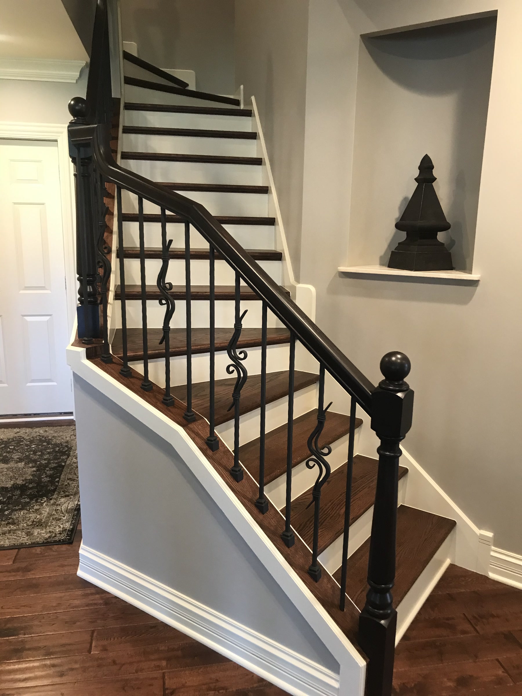 Staircase refinished to Rosewood with black metal balusters, Deerfield, IL