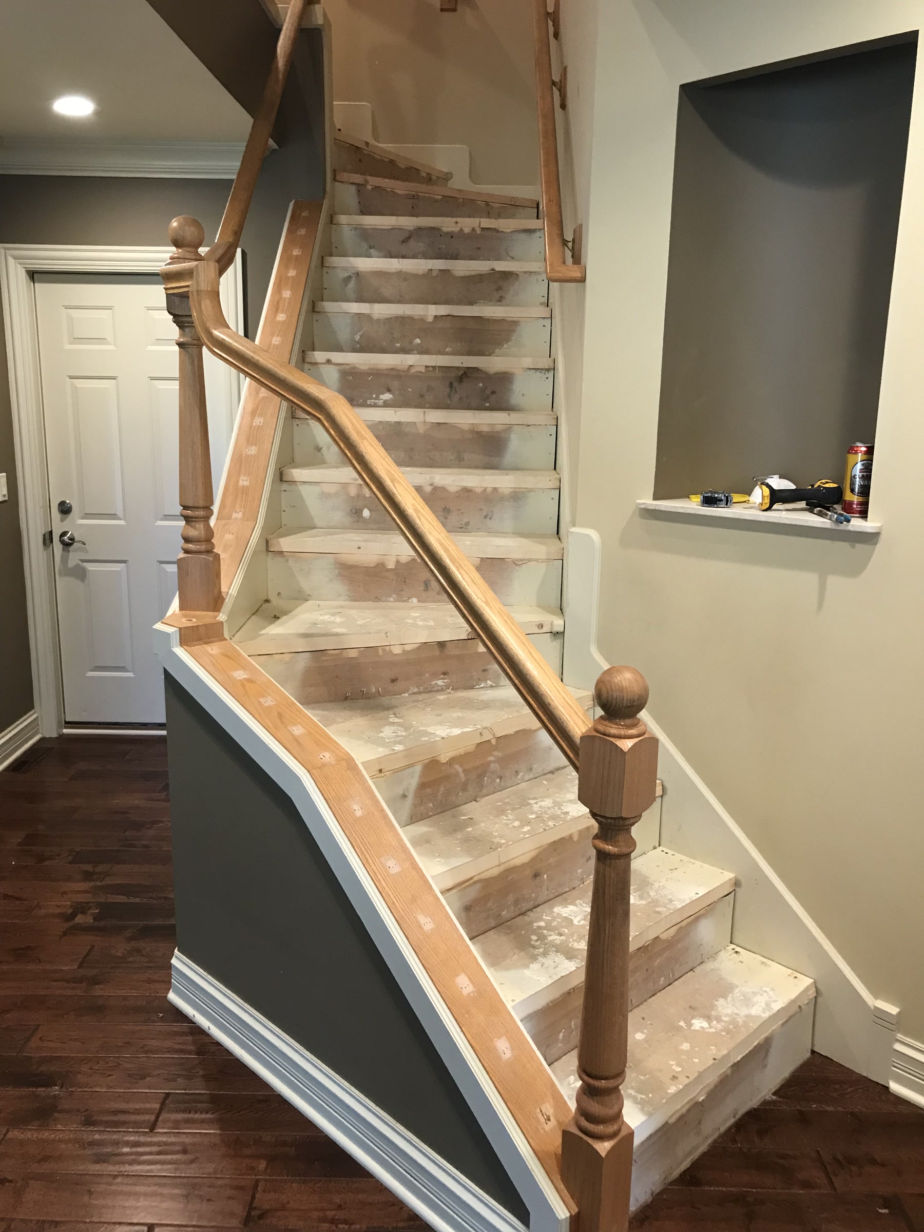 Staircase with a carpet runner and wood balusters before refinishing, Deerfield, IL