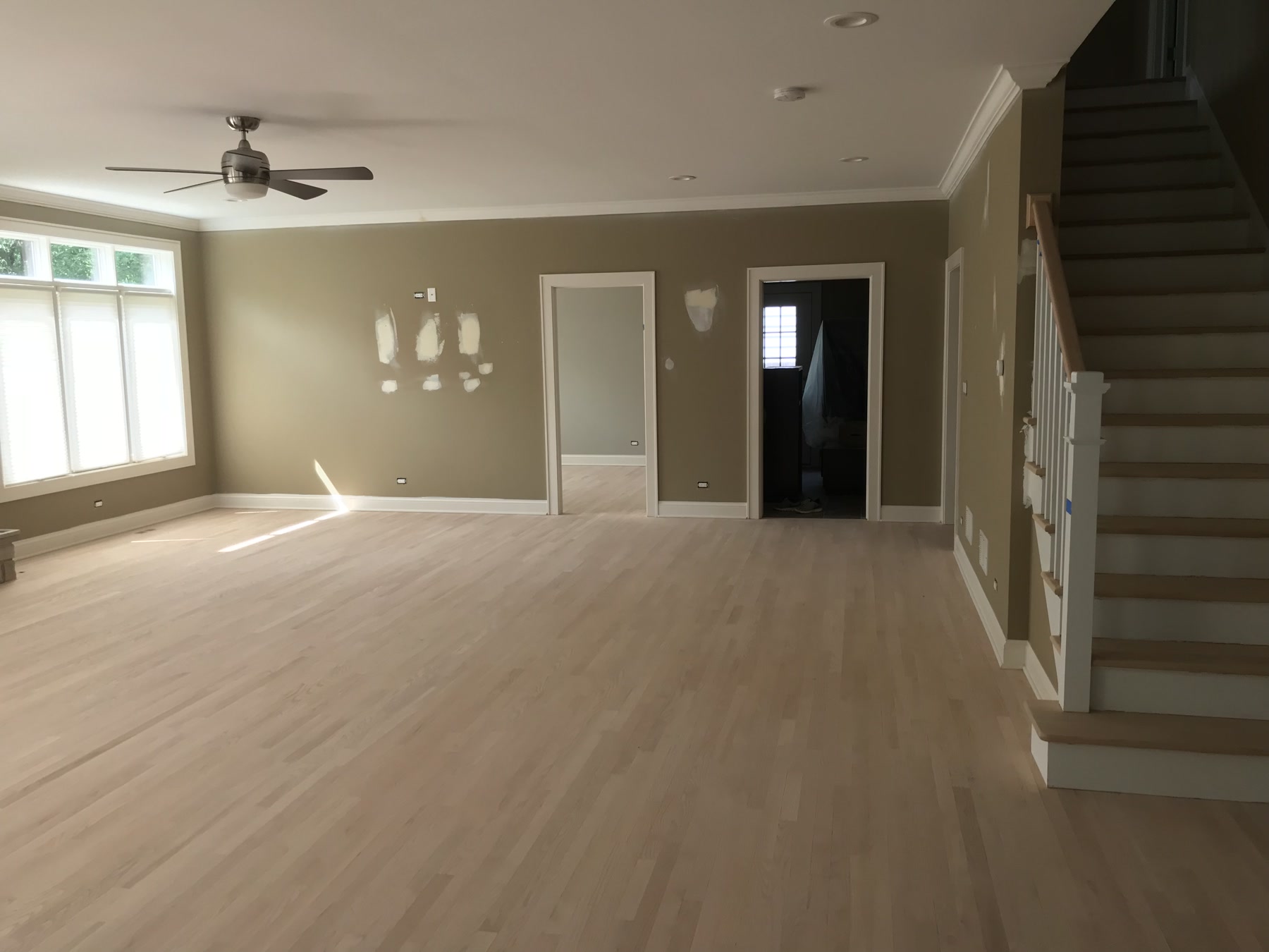 Freshly sanded raw hardwood floor in the great room before staining, Downers Grove, IL