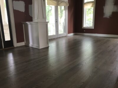 Silvered grey hardwood floor in the sitting room with a red accent wall, Downers Grove, IL