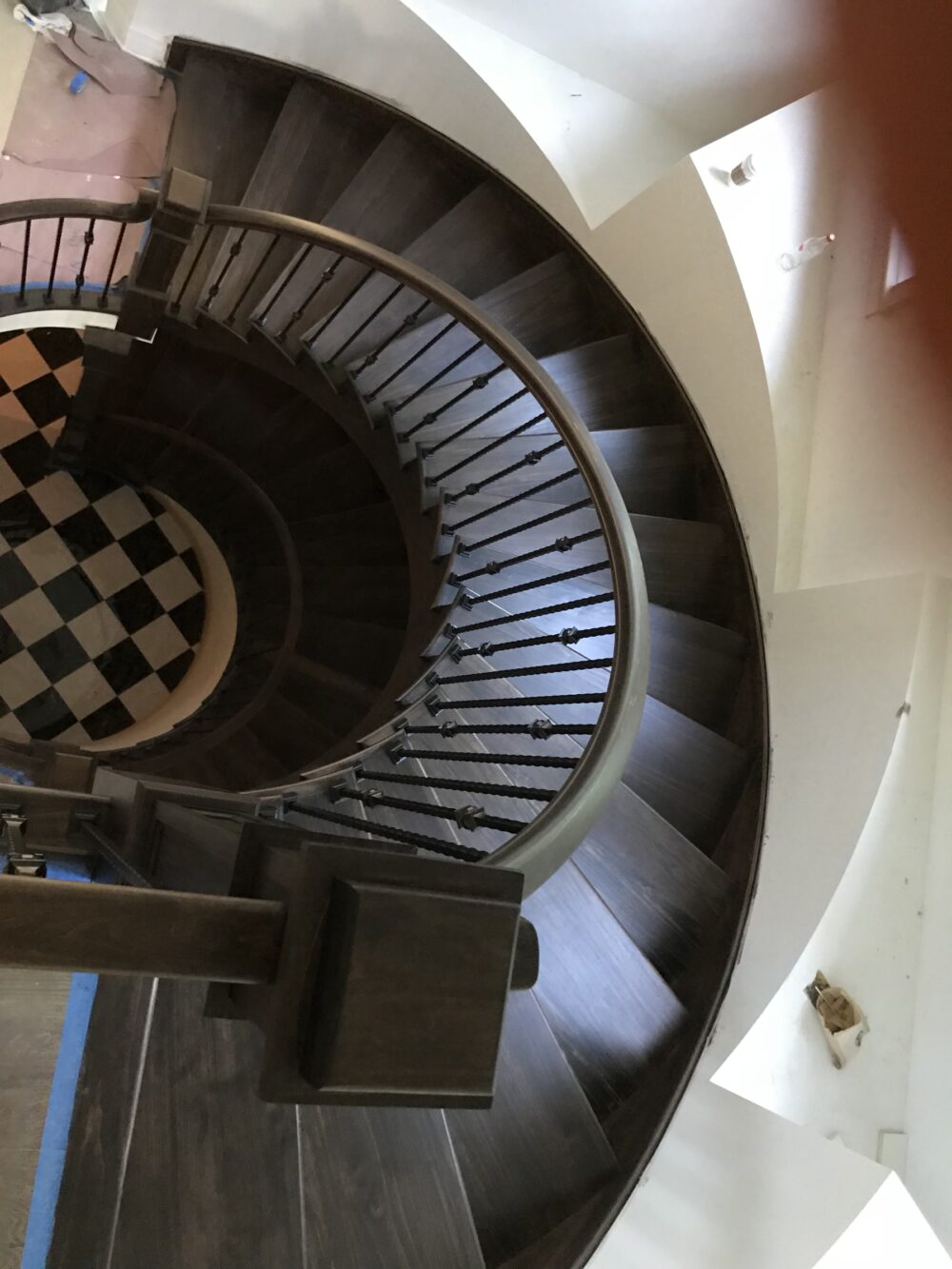 Curved staircase with dark treads below the chandelier, Downers Grove, IL