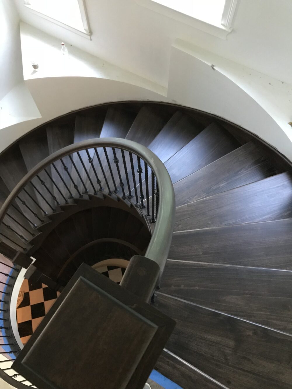 Spiral staircase seen from above over the checkered marble floor, Downers Grove, IL