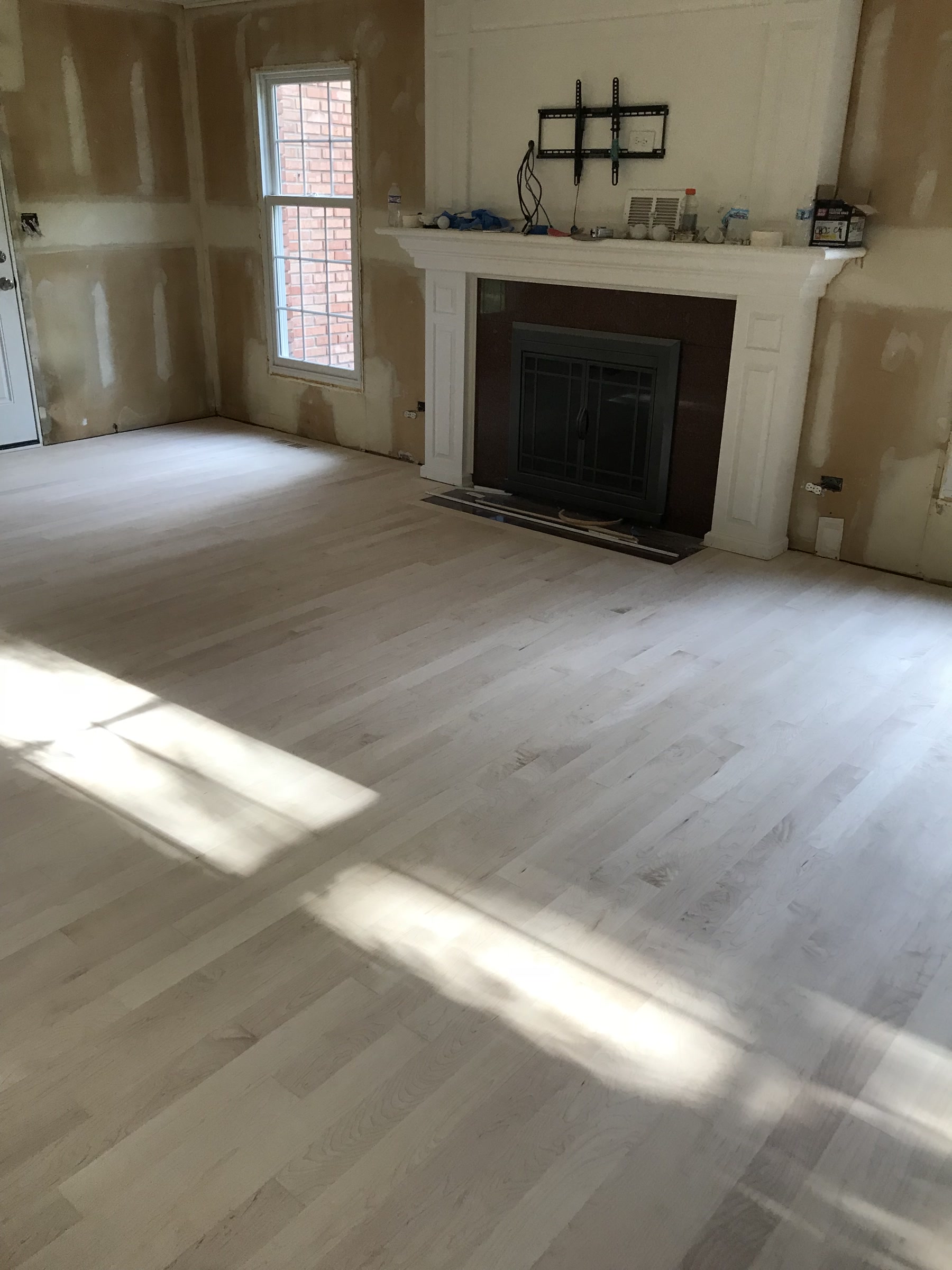 Raw sanded maple floor by the fireplace before espresso refinishing, Elmhurst, IL (in-process)