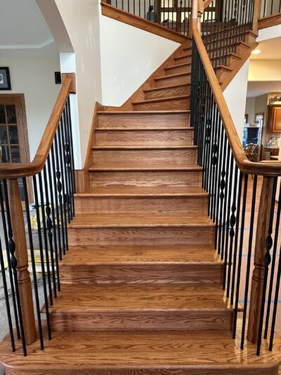 Refinished curved staircase with black metal balusters, Elmhurst, IL