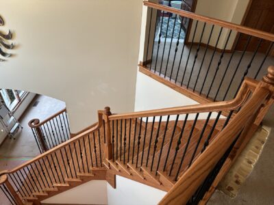 Curved staircase landing with black metal balusters, Elmhurst, IL