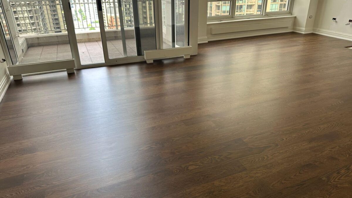Completed engineered white oak floor with Antique Brown stain and matte finish in the condo living room.