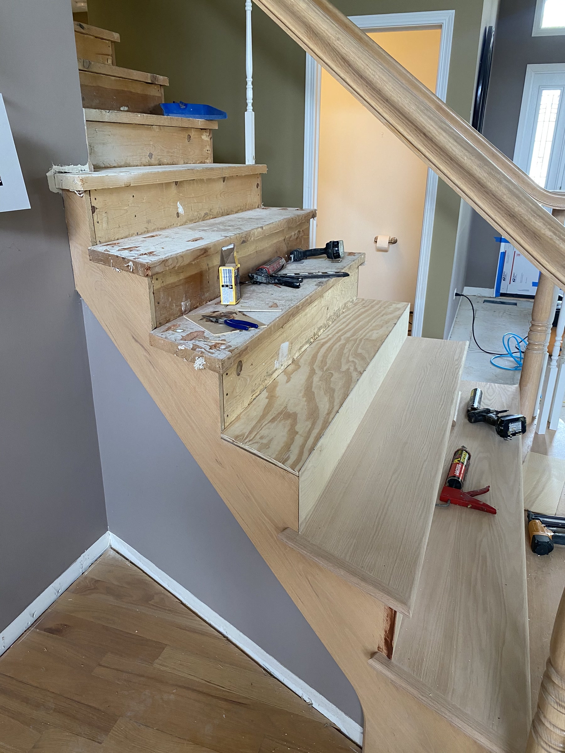 Staircase mid-build with bare treads, Glenview, IL (in-process)