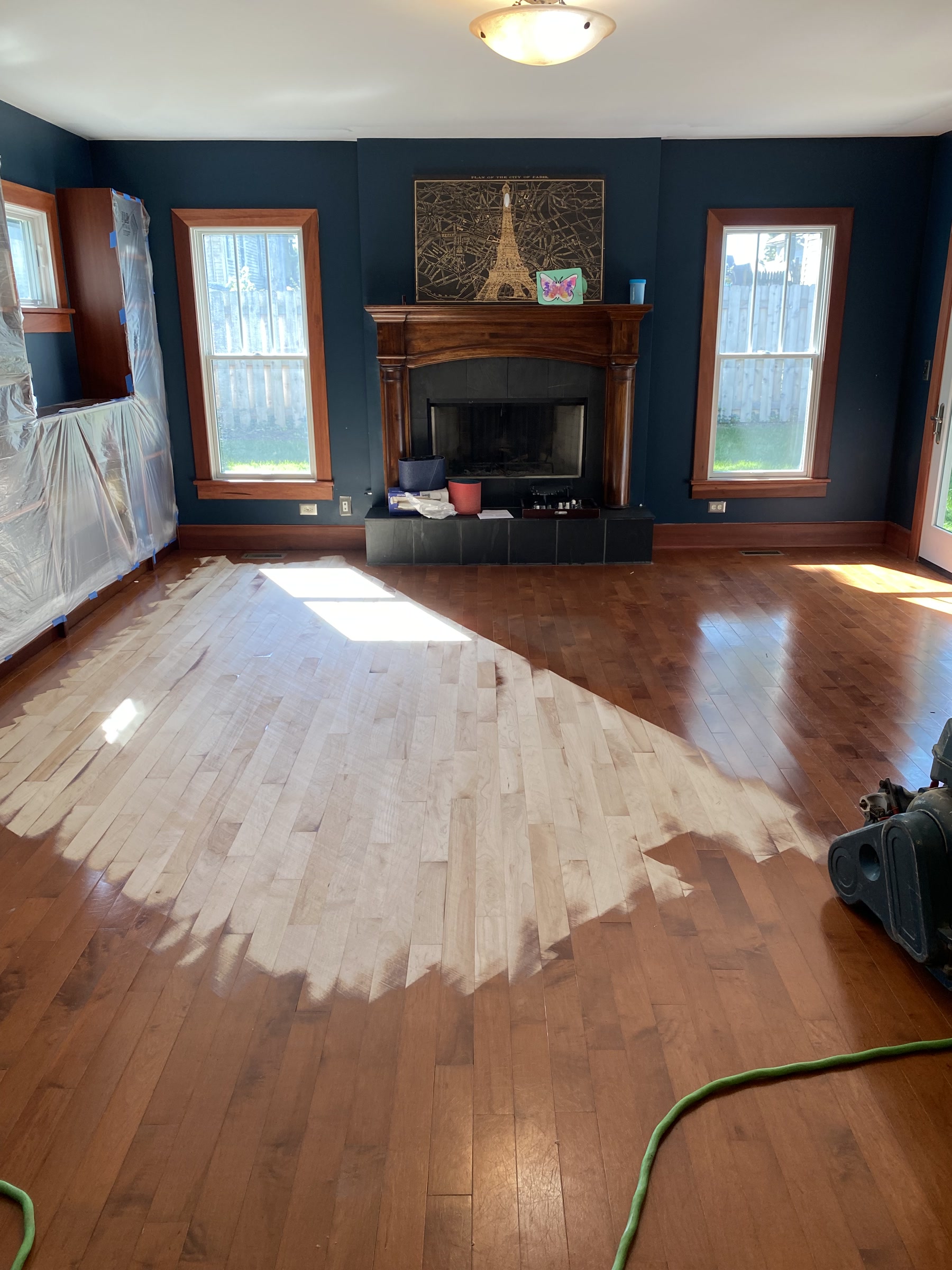 Living room maple floor mid-sanding, warm existing tone before refinishing, Highland Park, IL