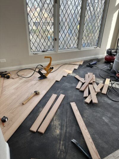 Diagonal red oak boards being installed over the moisture underlayment, Hinsdale, IL (in-process)