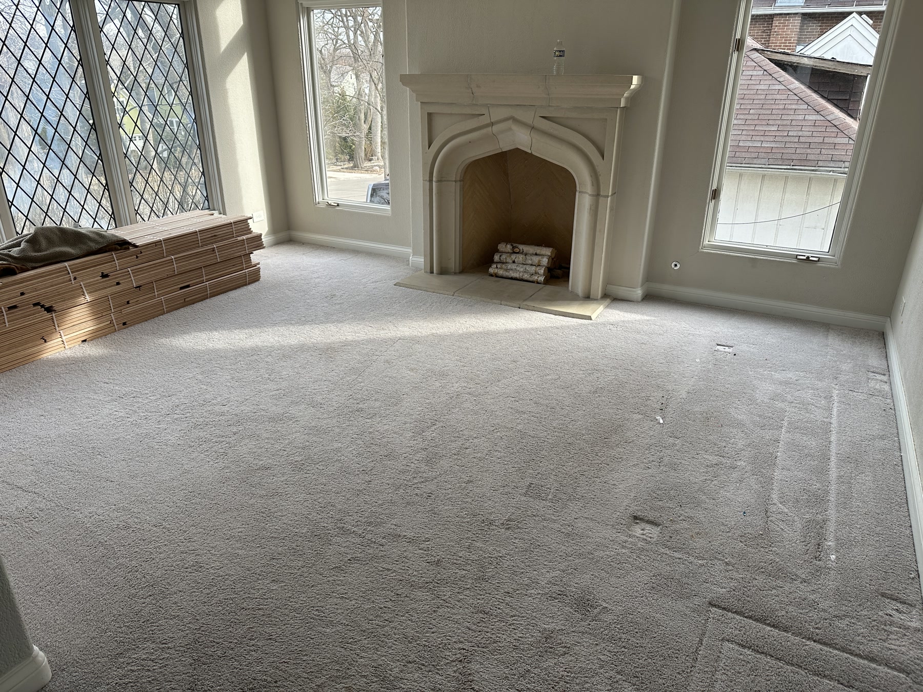 Carpeted room with the fireplace before the diagonal red oak installation, Hinsdale, IL