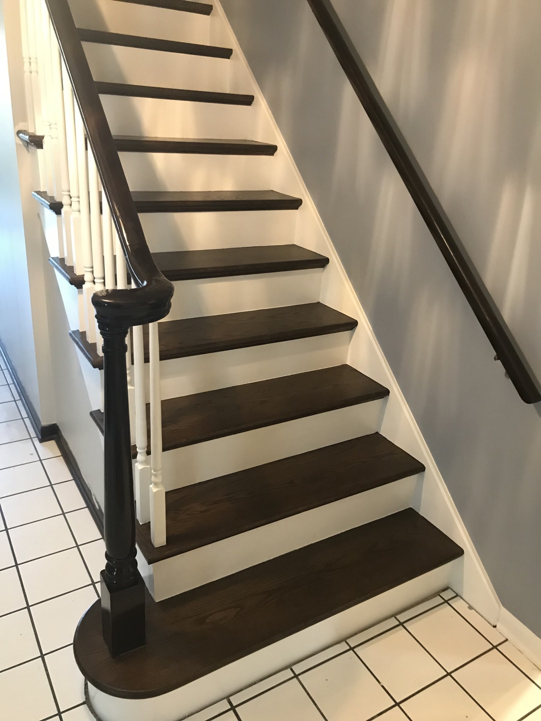 Finished staircase with espresso treads and carved newel posts, Lemont, IL