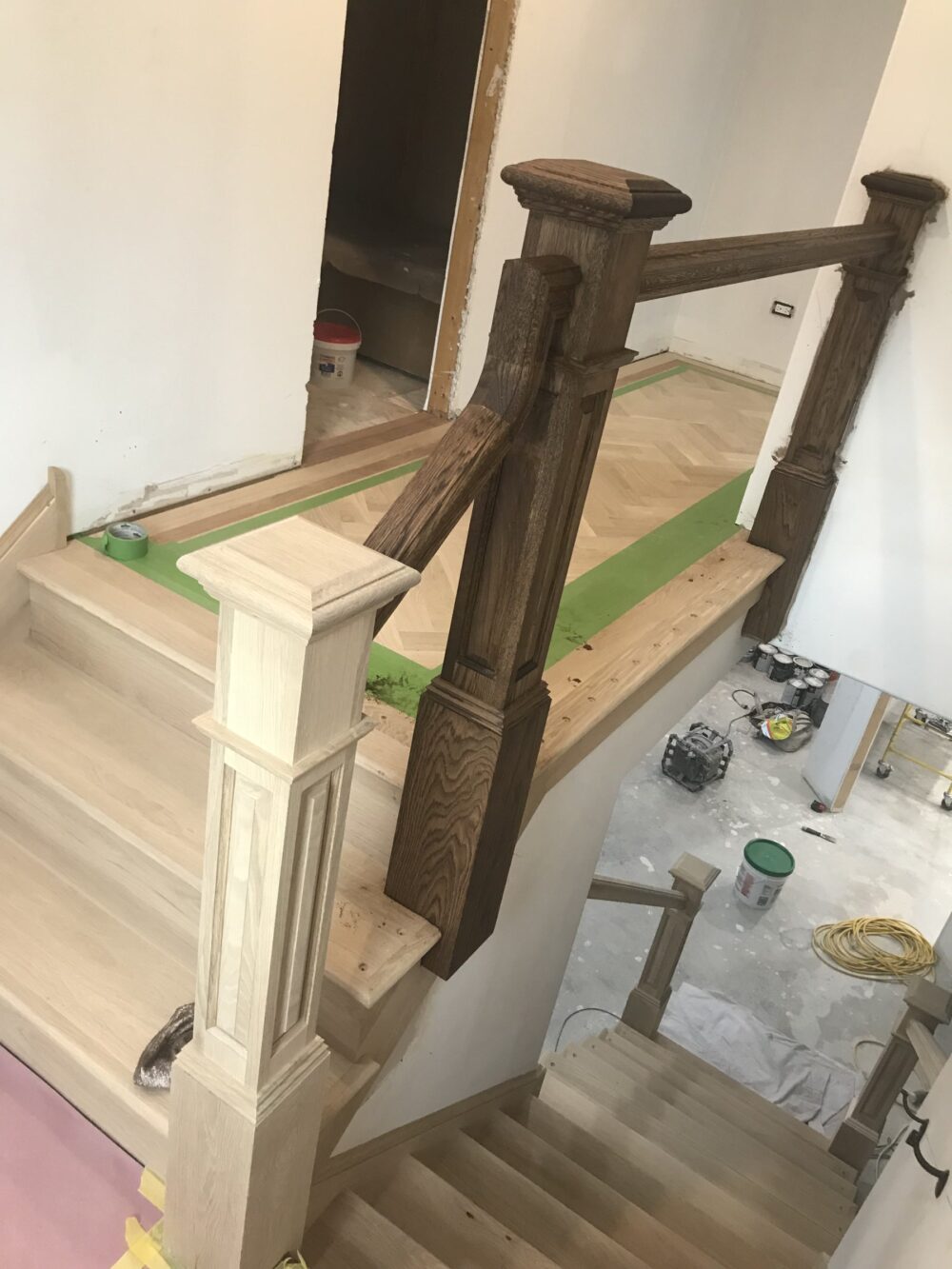 Staircase in-process with bare treads and a carved newel post, Lemont, IL (in-process)