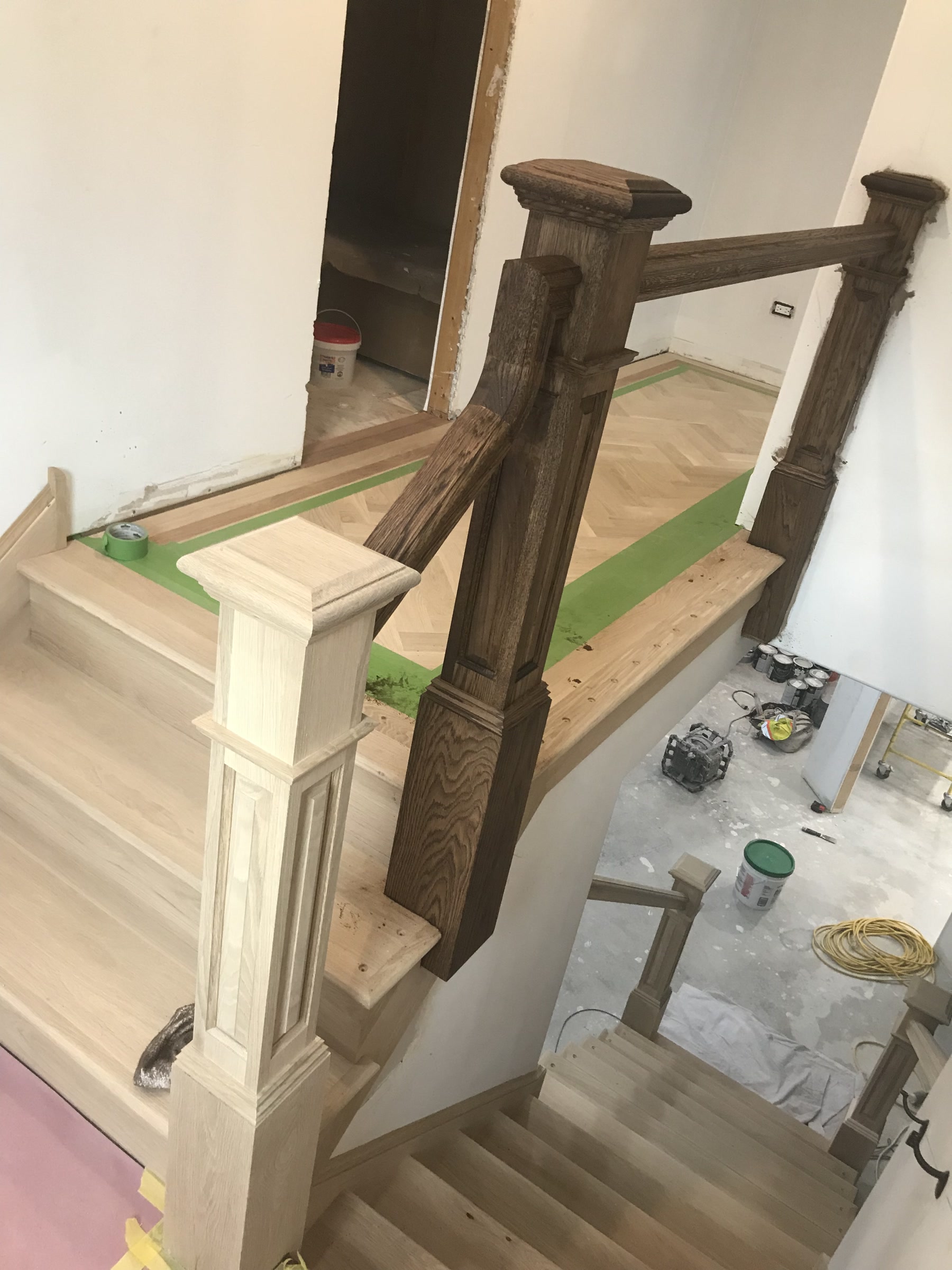 Staircase in-process with bare treads and a carved newel post, Lemont, IL (in-process)