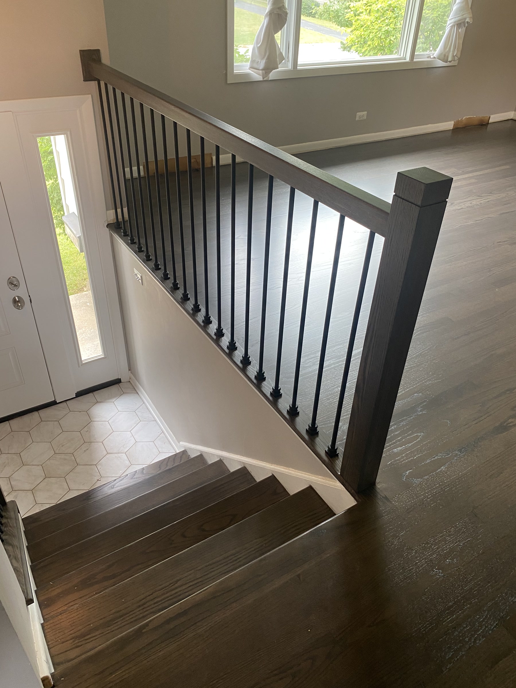 The staircase with new black metal balusters and warm grey treads, Lisle, IL